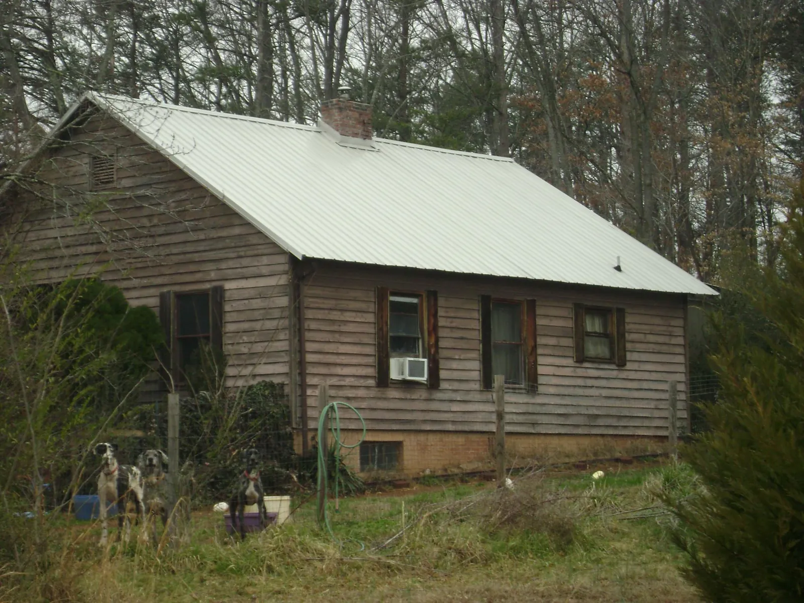 White metal roof on an old wood sided farmhouse, from a Metal Roof Installation job in Crawford