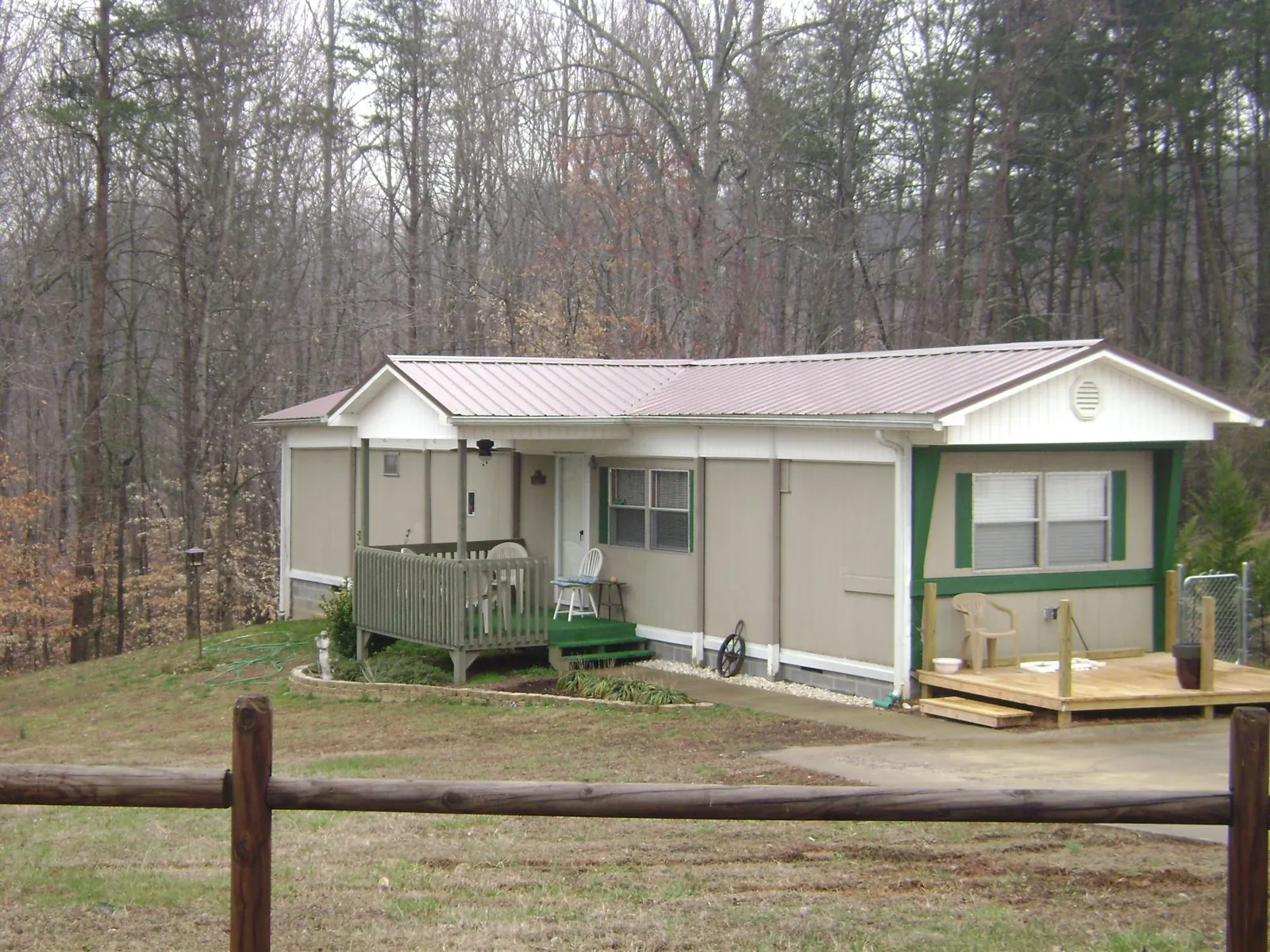 Mauve metal roof on a manufactured home with a new front deck in Crawford